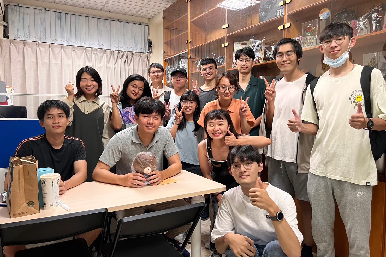 Prof. Hou (seated, right) poses with his students.